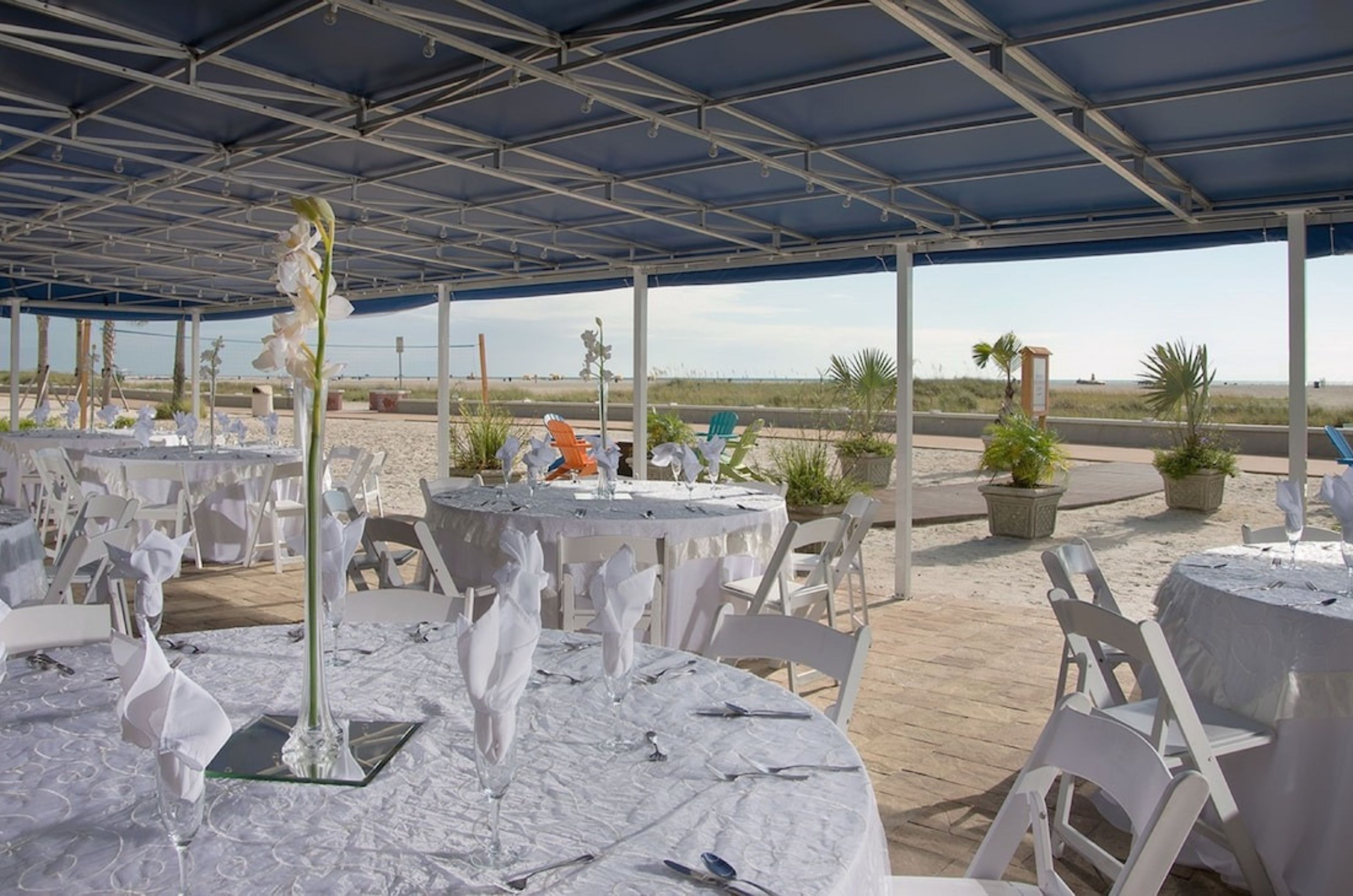 Elegant table settings in the beachside outdoor event space 