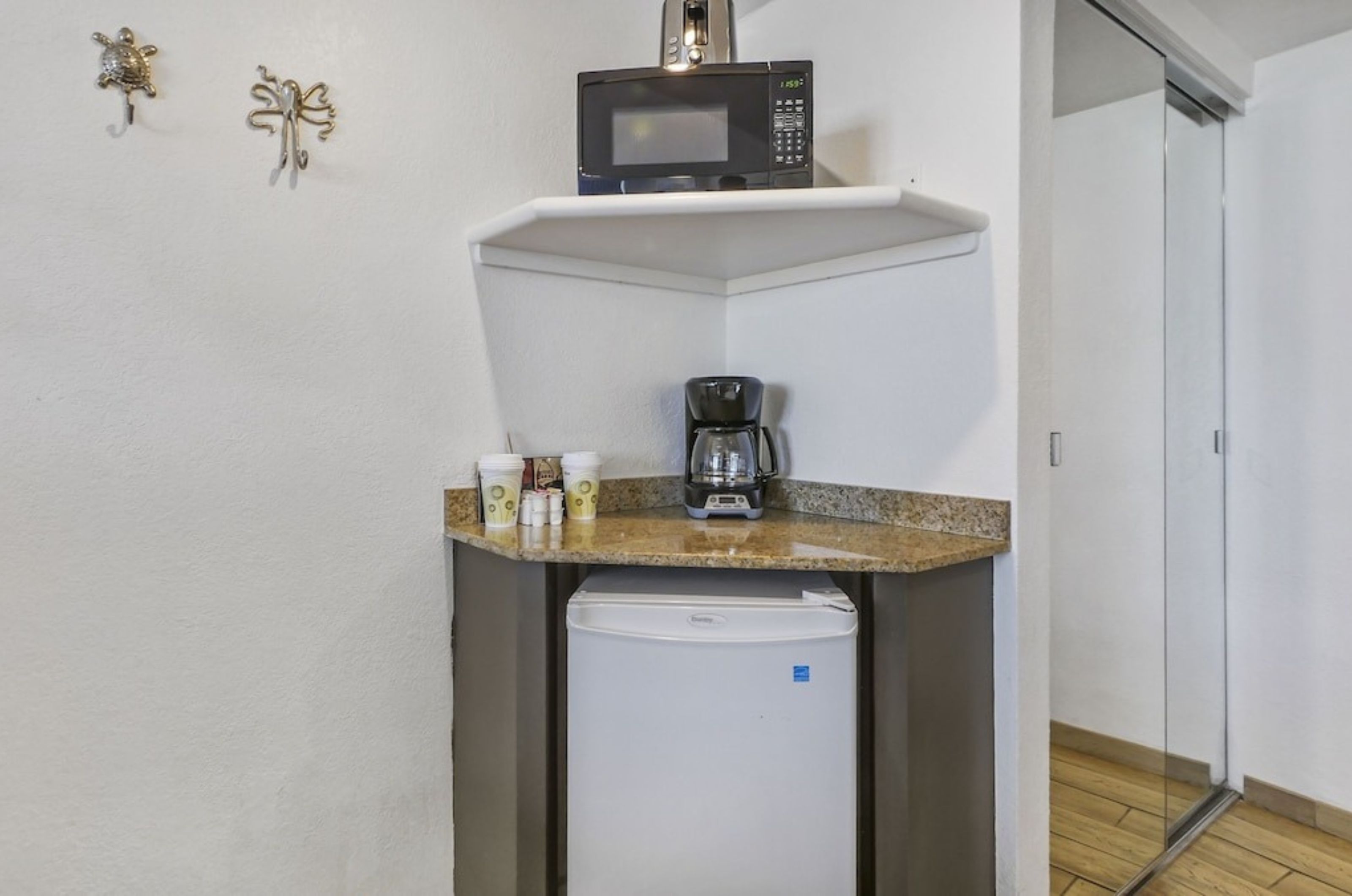 The in-room kitchenette with a microwave mini-fridge and coffee machine	