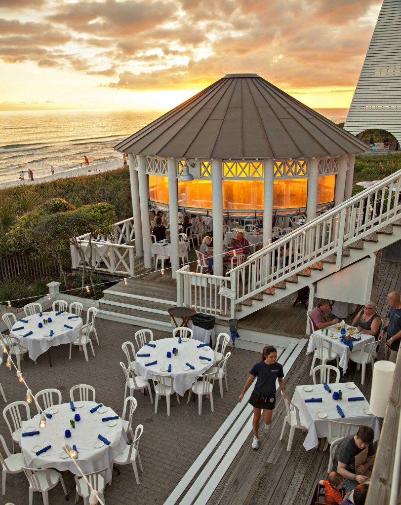 Sunset view of the columned gazebo, a few diners, and servers at Bud and Alley's in Seaside