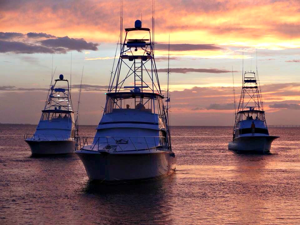 Three fishing boats at sunset during Destin Fishing Rodeo