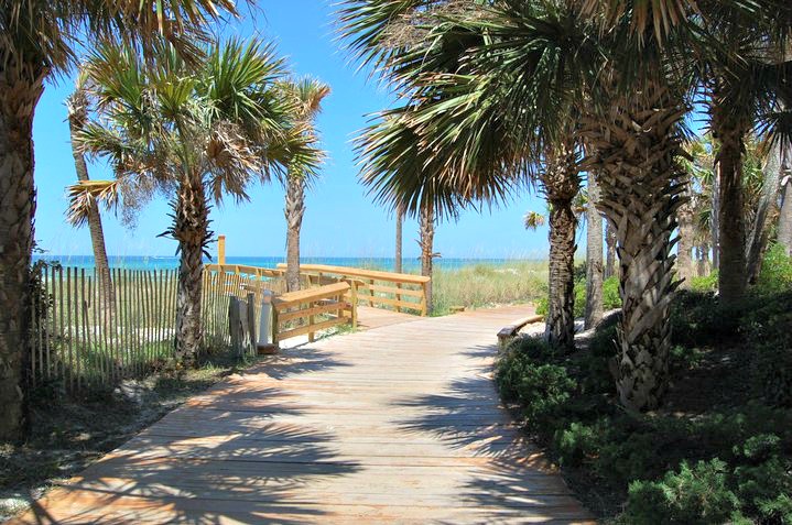 Palm-shaded path over the dunes at Boardwalk Beach Resort in Panama City Beach, Florida.