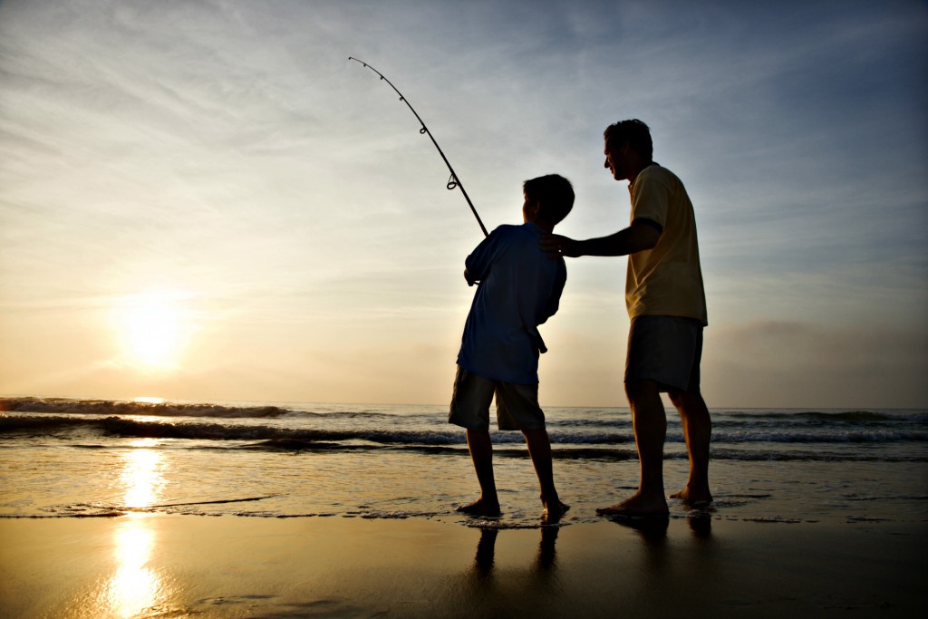 Father and son fishing from the beach for Gulf Coast fishing blog