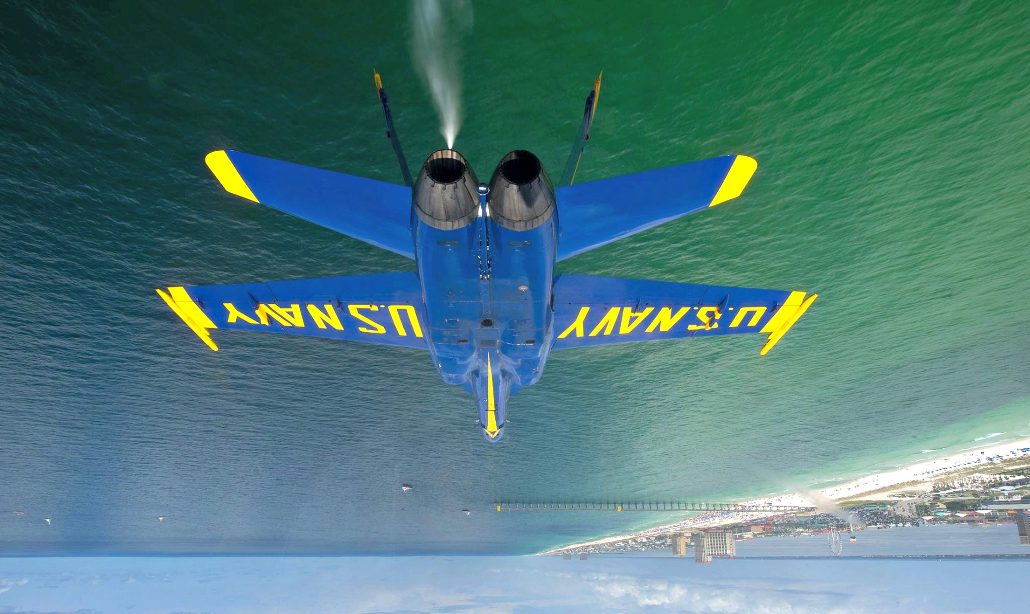 Blue Angels jet flying upside down over the Gulf of Mexico during a Blue Angels air show in Pensacola Beach