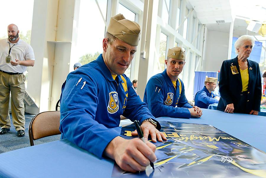 The Blue Angels sign autographs at Pensacola's National Naval Aviation Museum after their practice flights.