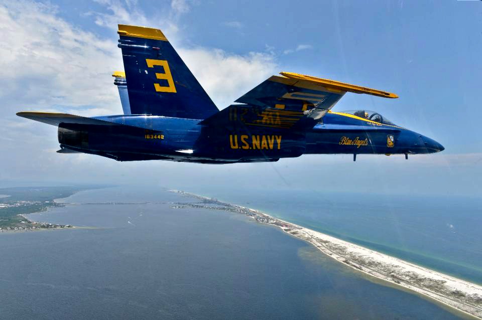 One of the Blue Angels flies over the Gulf and Pensacola Beach before the Blue Angels Homecoming Air Show.