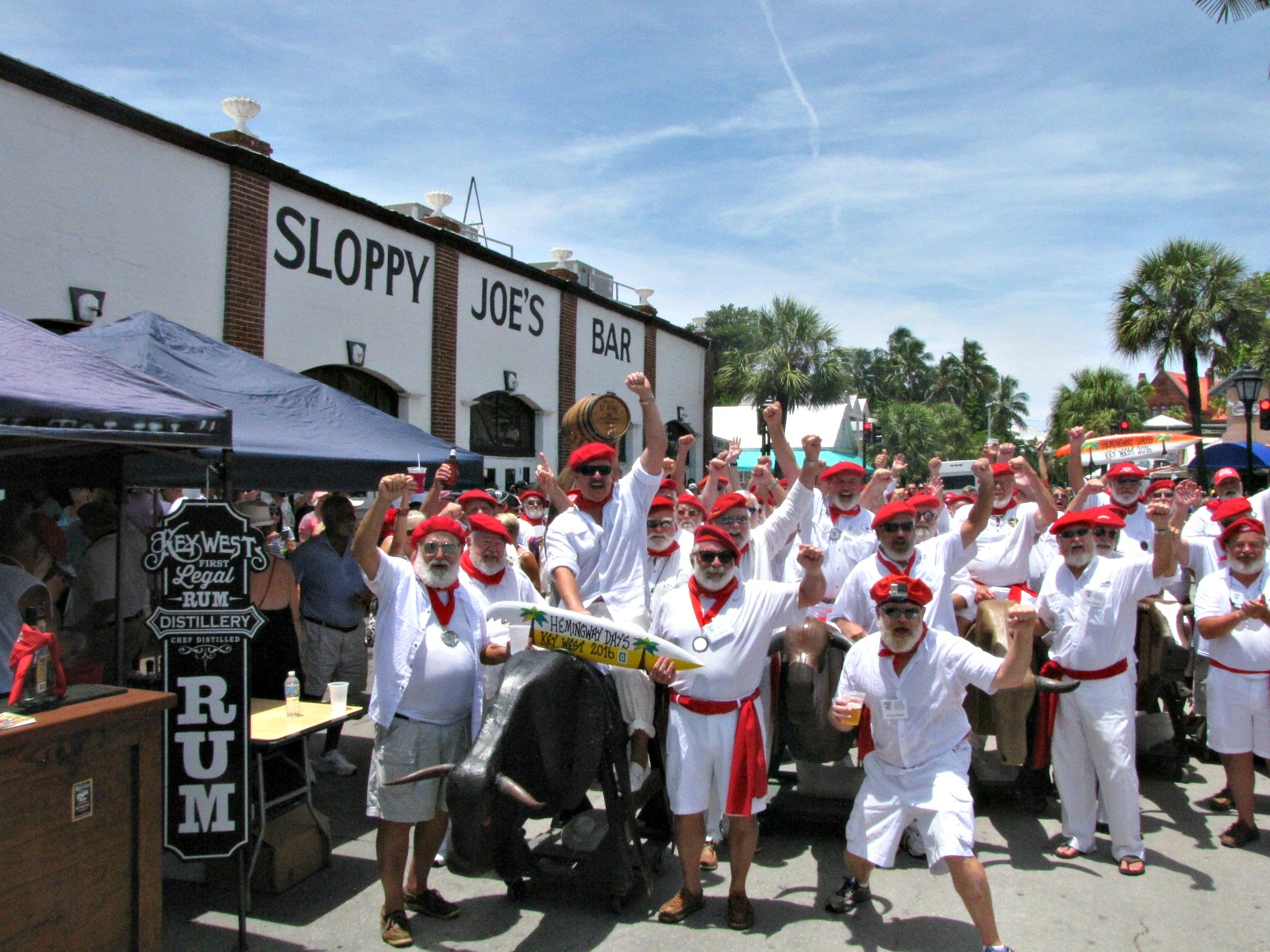 Hemingway look-alikes run with the "bulls" outside Sloppy Joe's Bar in Key West during Hemingway Days; 2017 Hemingway Days is scheduled for mid-July.