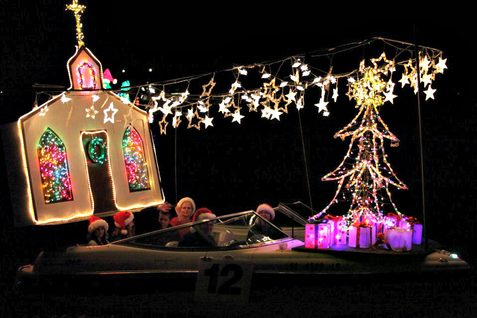 A church and Christmas tree light up this entry in the Venice, Florida, Christmas Boat Parade.