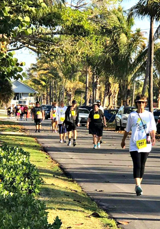 Walkers fill a tree-lined street during the Boca Grande 5K Run and Fun Walk.