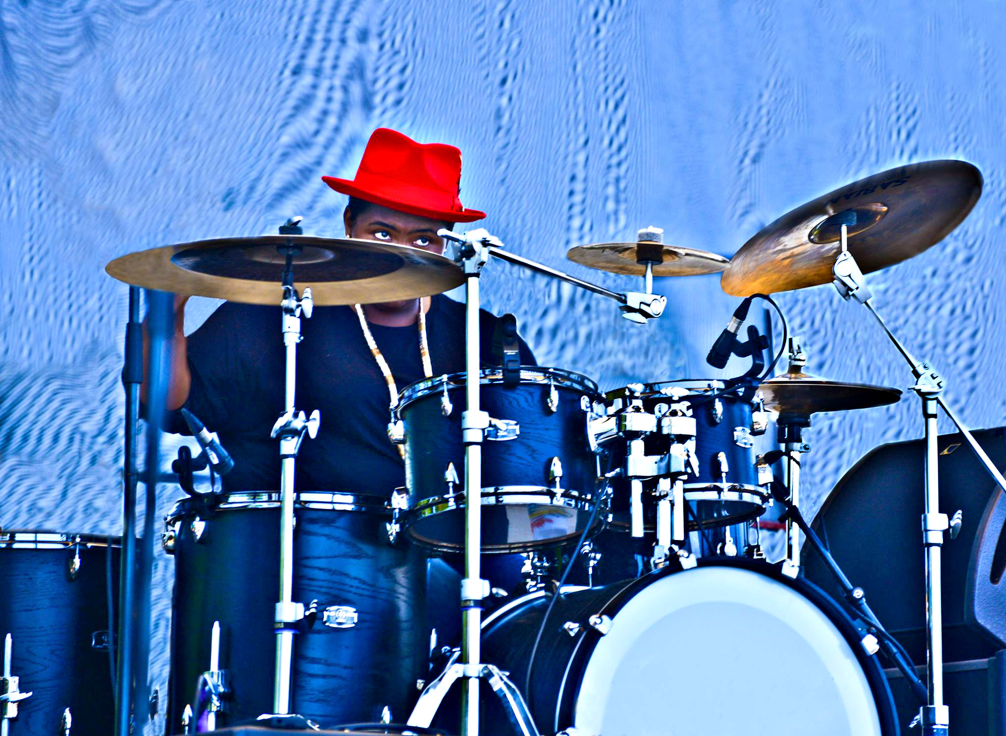 Drummer in red hat performs at Tampa Bay Blues Festival.