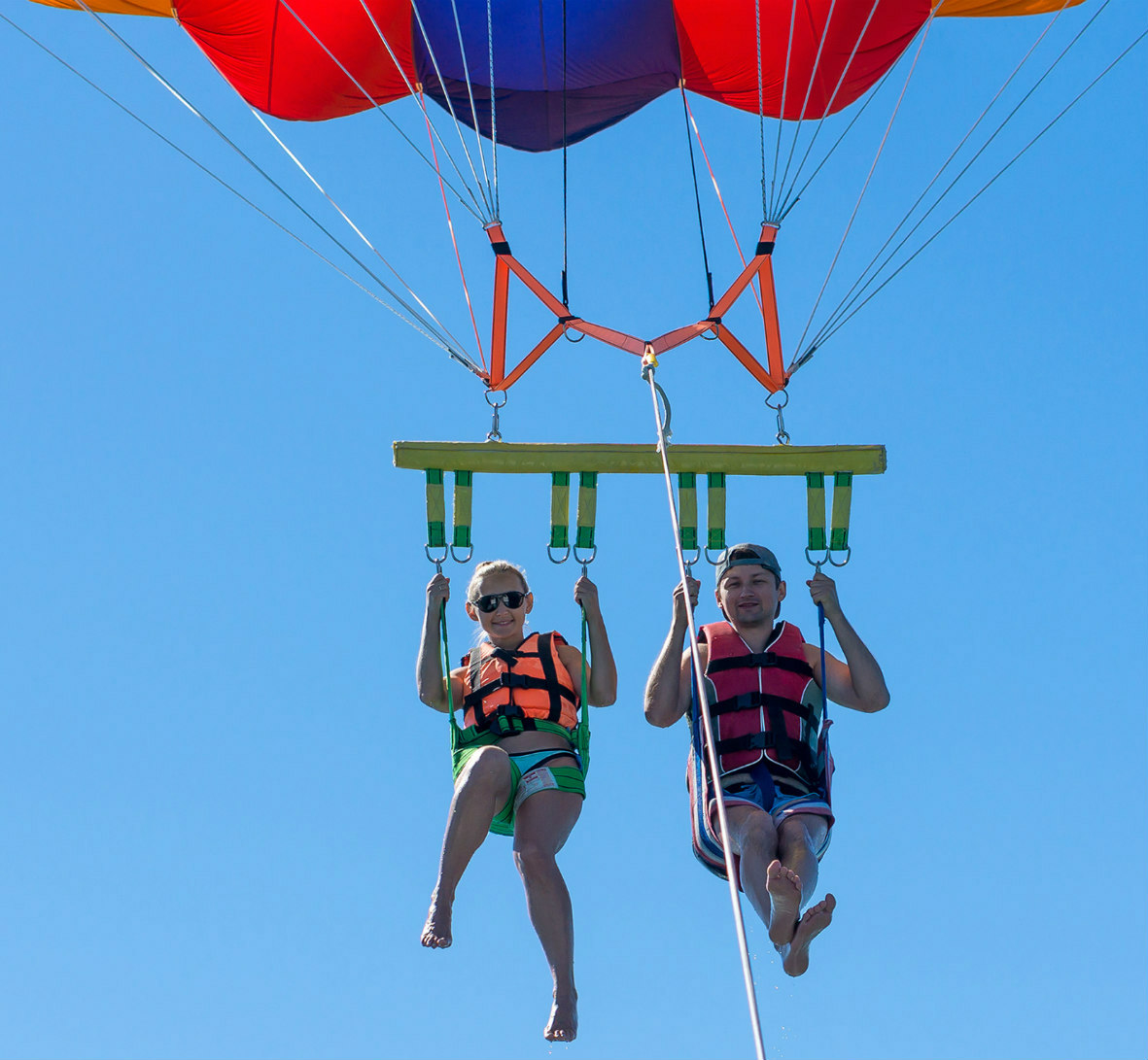 Young couple parasailing together