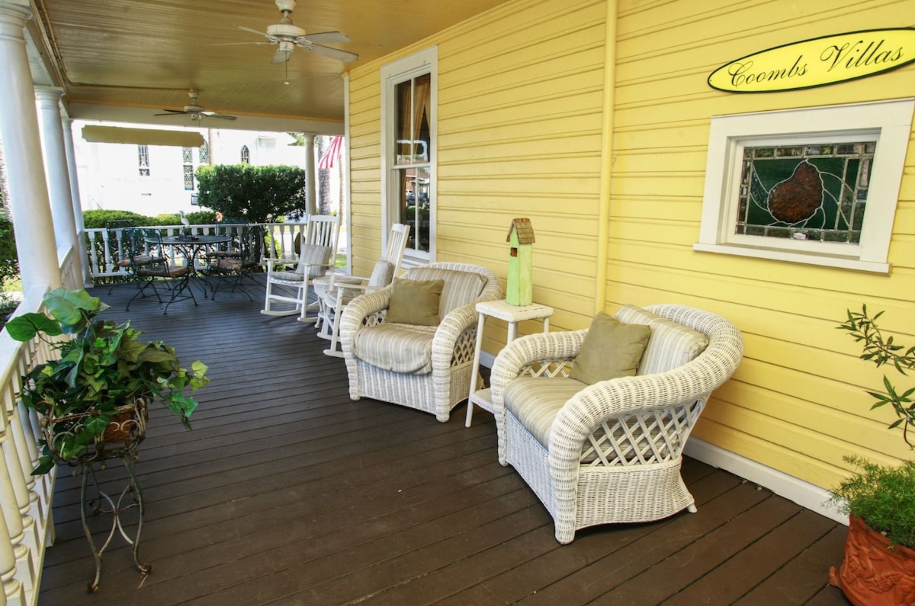 	A spacious outdoor porch with cozy chairs at Coombs Inn & Suites in Apalachicola Florida	