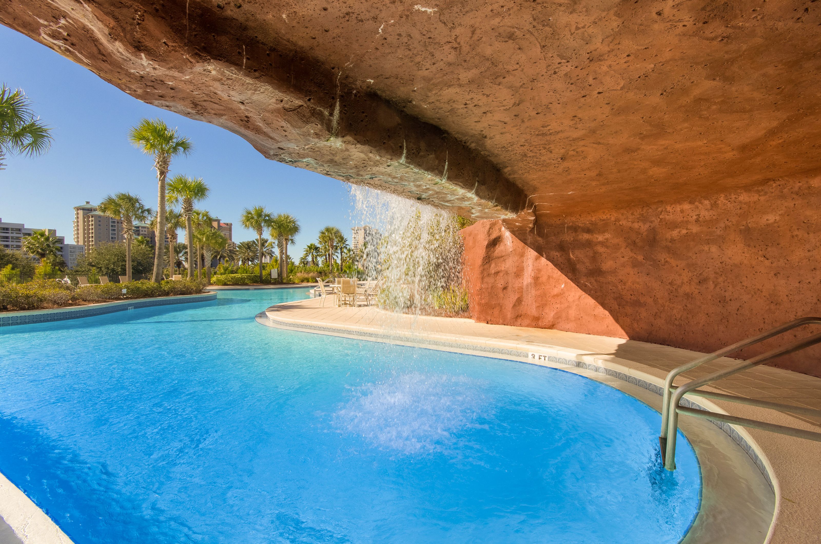 One end of the lagoon pool winds up in a cave-like structure with a waterfall cascading over the entrance