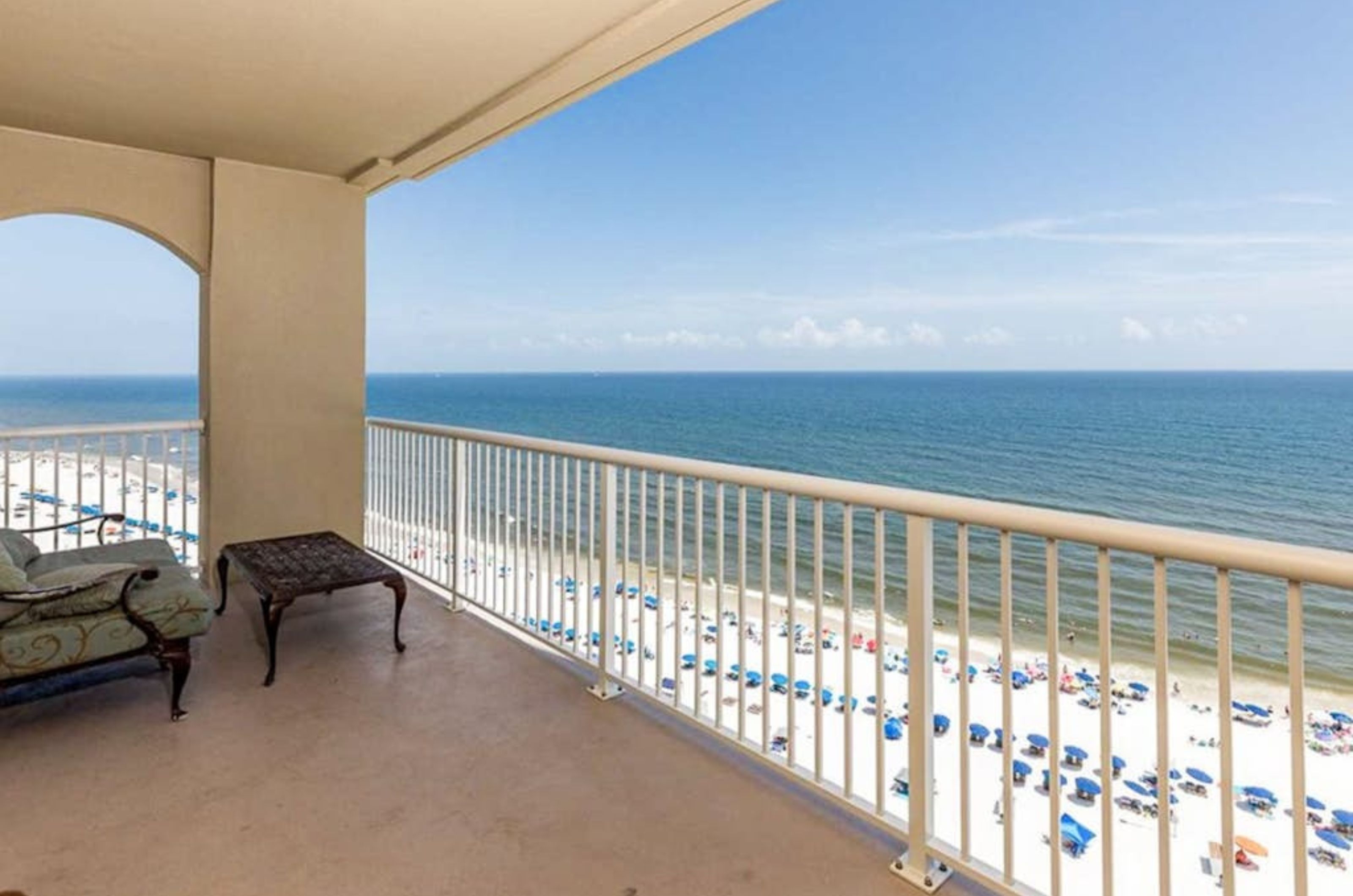 A private balcony overlooking the Gulf with a lounge chair at Escapes to the Shores