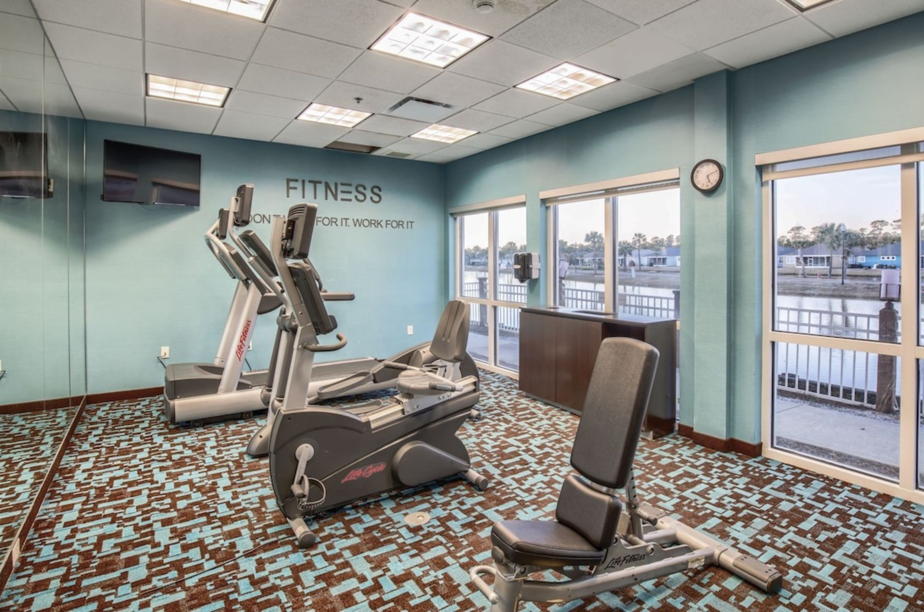 Cardio equipment and a workout bench in the fitness center at Fairfield Inn and Suites 