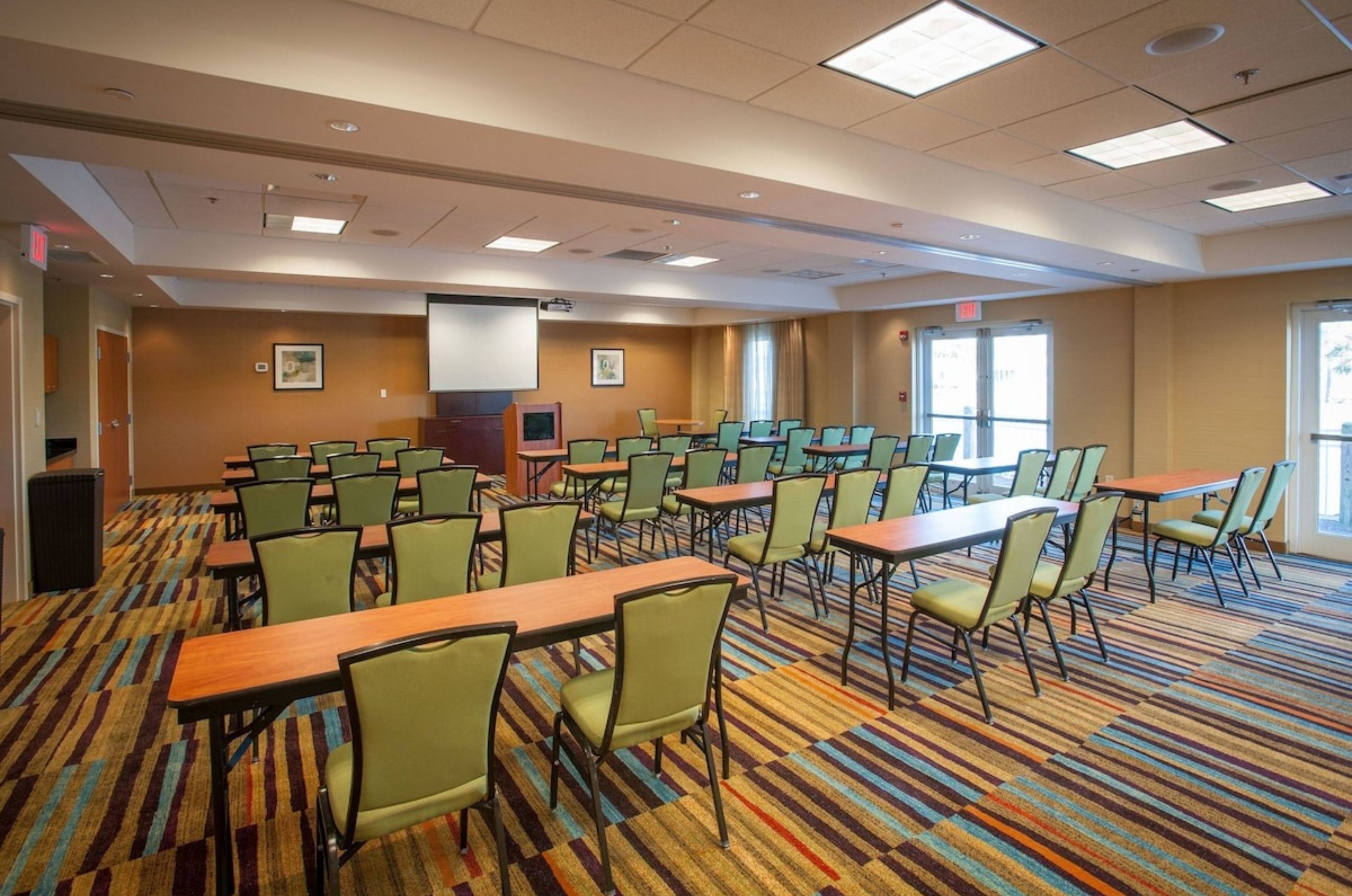 One of the meeting rooms with rows of tables and chairs at Fairfield Inn and Suites 