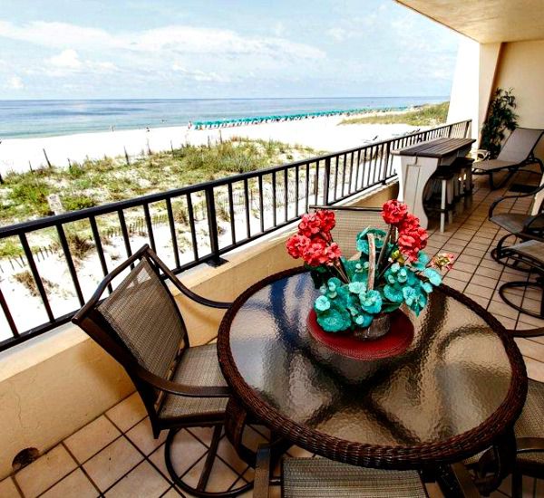 Beachfront balcony with table and chairs at Surf Dweller  Fort Walton Beach