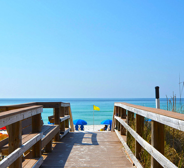 A wooden boardwalk offers easy beach access and an inviting view at Island Princess Fort Walton.