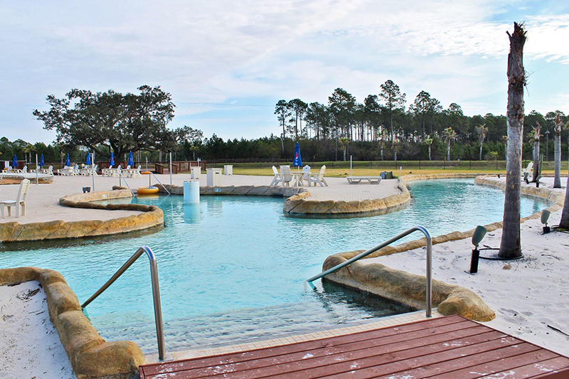 The sandy beach and easy entry pool makes it fun for the entire family at The Wharf in Orange Beach Alabama